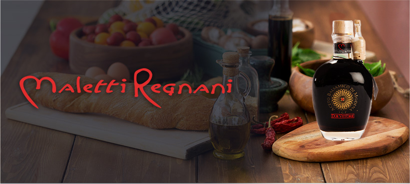 Maletti Regnani logo with balsamic vinegar on a cutting board and kitchen top background.