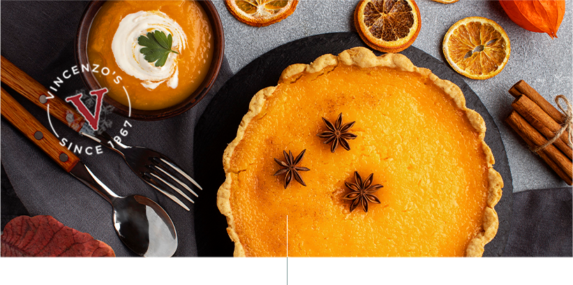 Pumpkin pie and pumpkin soup surrounded by a variety of garnishes.